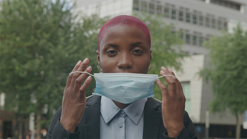 Woman Putting on a Mask