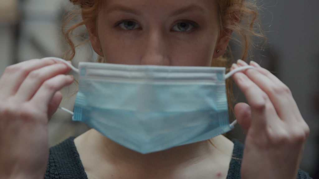 Woman Putting on a Mask