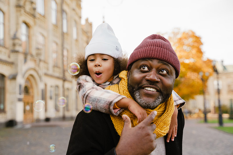 Family with daughter blowing bubbles