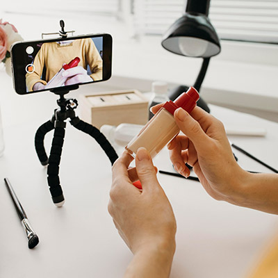 Woman recording video on mobile phone