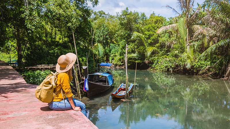 Woman sitting near water in Thailand