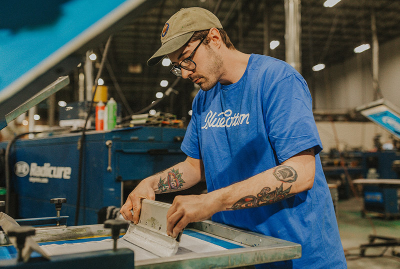 Man BlueCotton employee working on a machine